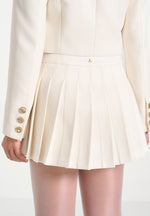 joelle-asymmetric-pleated-mini-skirt-cream